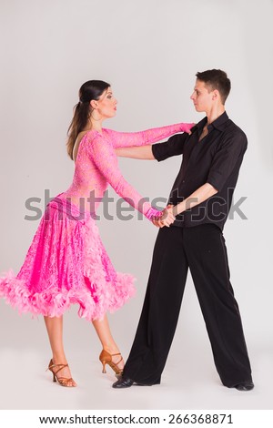 Ballroom dancing. Man and woman posing in dance pose on white. Man and woman dancing ballroom dances. Beautiful man and woman doing the dance steps. Dance poses.