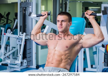 Handsome muscular male body. Male bodybuilder. Muscles of the arms, torso, abdominal muscles. Bodybuilding pose. Concept l bodybuilding.