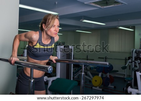 Sports, bodybuilding. Attractive woman in gym.Fitness in the gym. Strength training and beauty. Picture a strong woman. Blonde sexy girl fitness in sexy wear with perfect body posing in the gym.