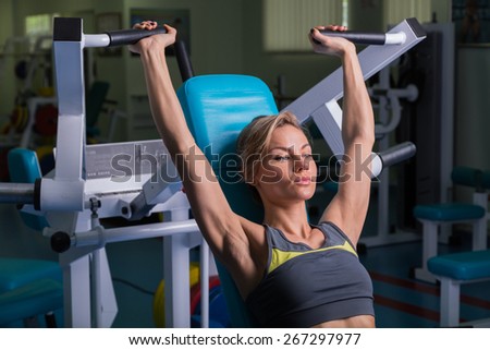 Sports, bodybuilding. Attractive woman in gym.Fitness in the gym. Strength training and beauty. Picture a strong woman. Blonde sexy girl fitness in sexy wear with perfect body posing in the gym.