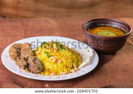 Tasty food on a plate. Rice with meat and sauce.