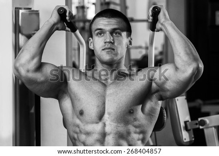 The process of physical exercise . The man is engaged in the gym. Training in the gym. Healthy lifestyle. Photo in creative.
