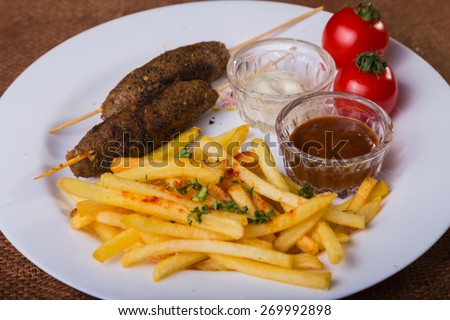 Tasty food. French fries with meat.