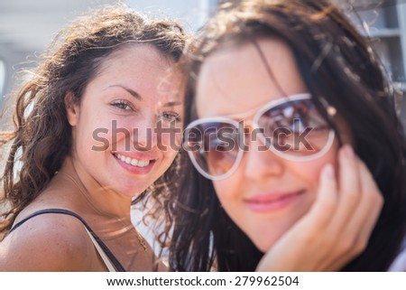 Two brunette on a yacht, portrait. Concept travel. Two girls laughing and travel.