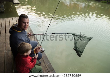 Dad and son on fishing. Family weekend leisure. Family fishing at the lake.