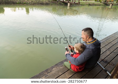 Dad and son on fishing. Family weekend leisure. Family fishing at the lake.