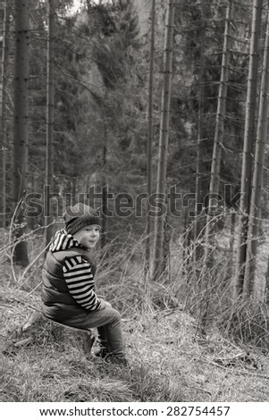 Little traveler. Little boy is resting in the forest. Travel, active children\'s recreation.