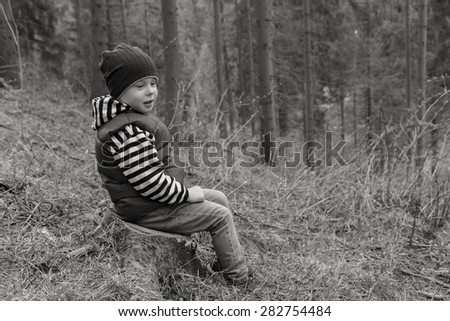 Little traveler. Little boy is resting in the forest. Travel, active children\'s recreation.