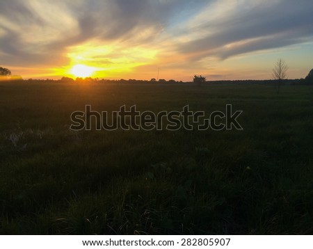 Beautiful sunset. Sunset on the field. Beautiful evening landscape.