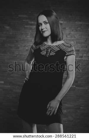 Portrait of a beautiful, charming brunette. Black and white photography. Fashion photography.