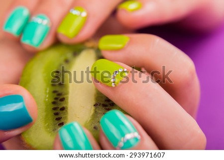 Beautiful manicure closeup. Luxurious manicure on nails. Nails in different colors. Hand Care.