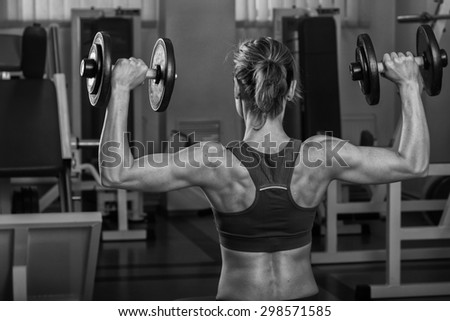 Power gym workout, women workout. Beautiful blonde trains in the gym