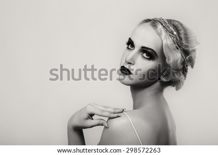 Portrait of a gorgeous blonde. The mystery, sadness, insecurity, human emotions. The girl in the style of the 20s.