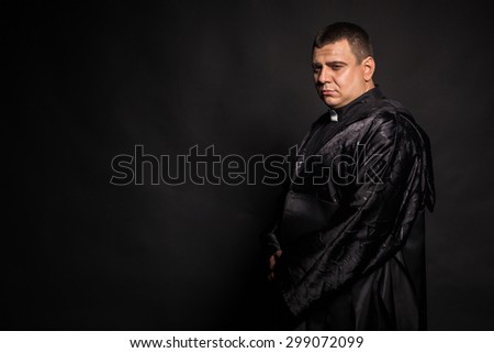 The actor plays the role of a priest. Portrait of the actor, emotional game.