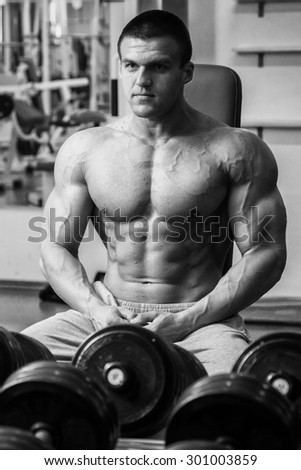 Healthy, strong muscular guy in the gym. Healthy lifestyle concept. Bodybuilding, sports, power lifting.