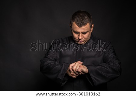 The actor plays the role of a priest. Portrait of the actor, emotional game.