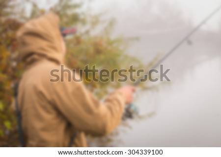 Fishing in the fall. Blurring background.