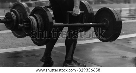 Lifting weights standing. Athlete takes deadlift. Power Sports. Photos for sporting magazines, posters, backdrops and websites.