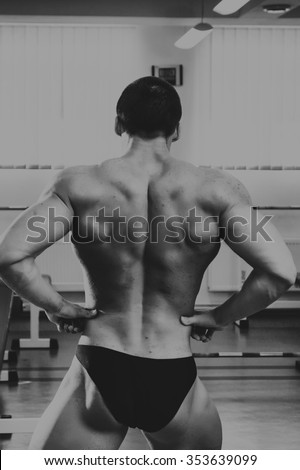 Bodybuilder at the gym. Work on hands tell muscles. Exhausting workouts to an end. Photos for sporting magazines and websites.