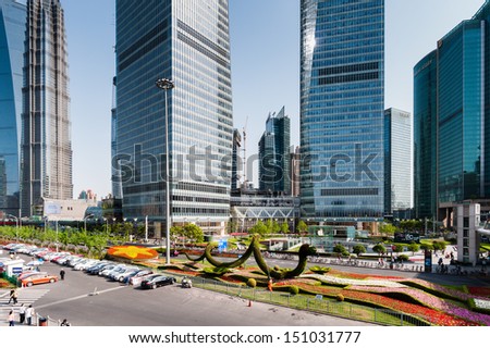 SHANGHAI - MAY 2: skyscrapers and street on May 2, 2013 in Shanghai. Shanghai is the largest city by population in the world with 23 million as in 2010.