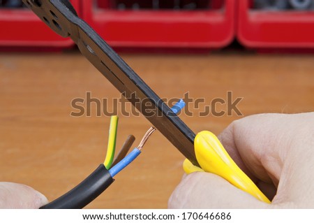 Wire stripper stripping the blue wire