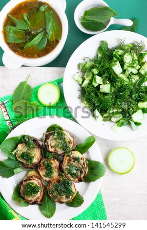 vegetarian green dinner - vegetable soup, fried vegetable marrow and salad