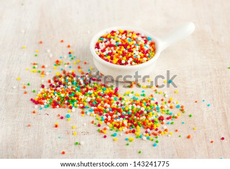many bright small coloured candy for decoration in the gravy boat