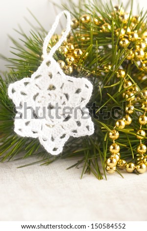 crocheted white star and beads on the Christmas tree