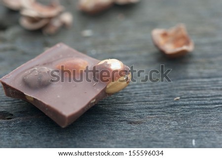 milk chocolate in bars with hazelnut on the wood board