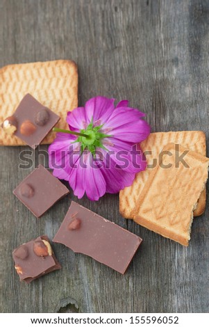 cut flowers chocolate and pastry on the wood board