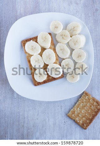 dry biscuit with banana on the white plate