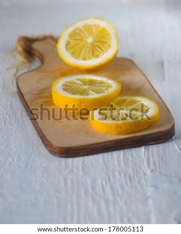 Sliced juicy sour lemon on a cutting board on a light background