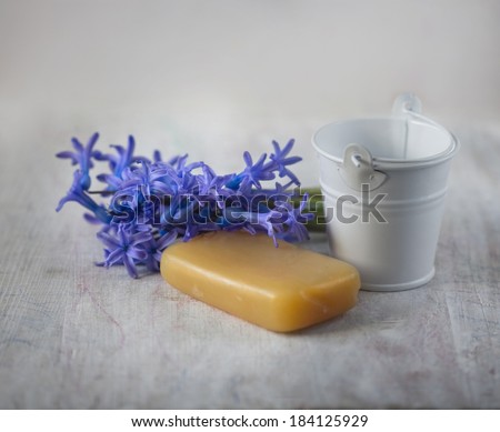 natural soap, purple spring flowers and decorative small bucket