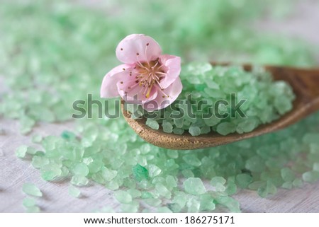 aromatic salt aqua water bath on a wooden spoon and flower