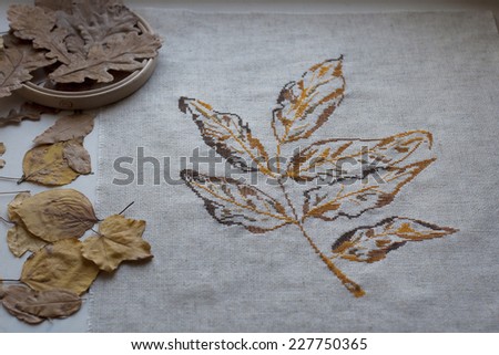 embroidered on the canvas autumn leaf with dry brown leaves and wooden Hoop
