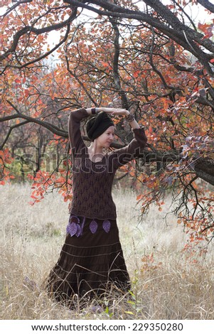 Young woman dancing ritual magic dance outdoors