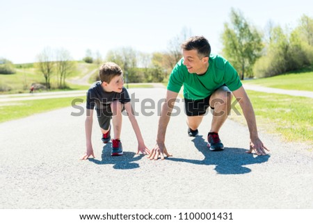 father with son sport running together outside