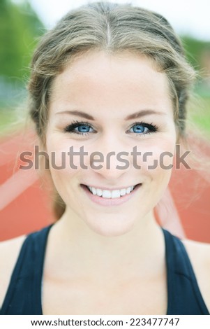 Smiling young woman jogging track