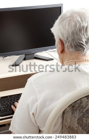 A senior person in front of his computer