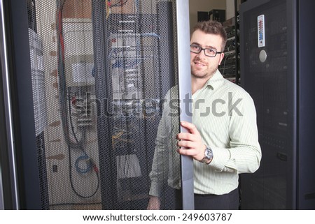 A happy worker technician at work with computer