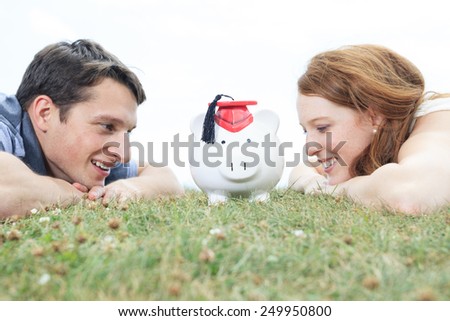 money, outside, finance and relationships concept - smiling couple with piggybank