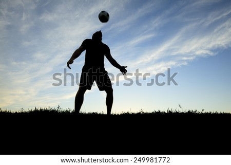 A soccer player play in back lit day time