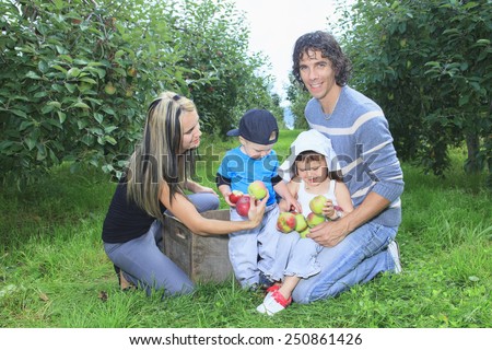 A happy family of four attractive caucasian catch apple