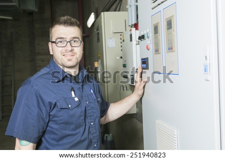 repairman engineer control panel valve equipment in a boiler house