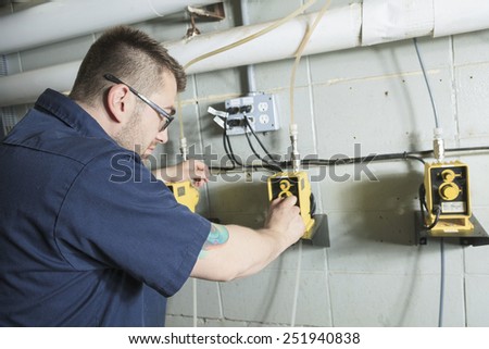 repairman engineer of fire engineering system or heating system open the valve equipment in a boiler house