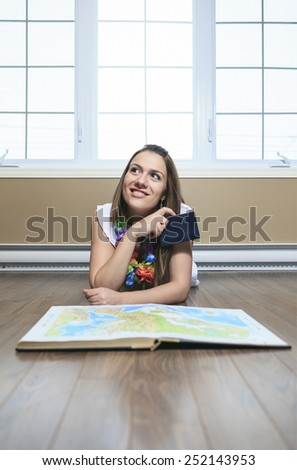 A Cheerful woman looking at a MAP in the living room