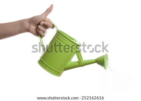 a hand with a watering can over a white background