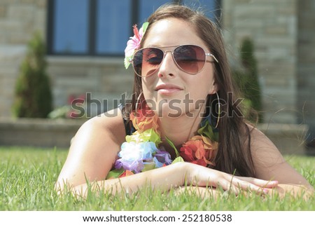 A young woman lay down and take a rest on the green grass