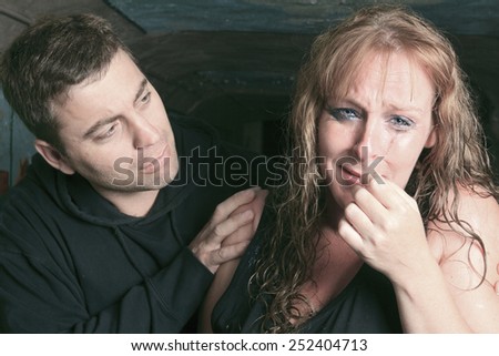 A men consoling woman and trying to calm down.