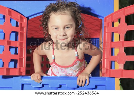 little girl play in a little house